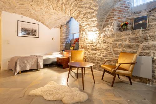 a room with a bed and a table and chairs at Old Town - Viru Gate Apartment in Tallinn