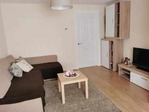 a living room with a couch and a coffee table at Entire 3 bedroom house Manchester free parking in Manchester