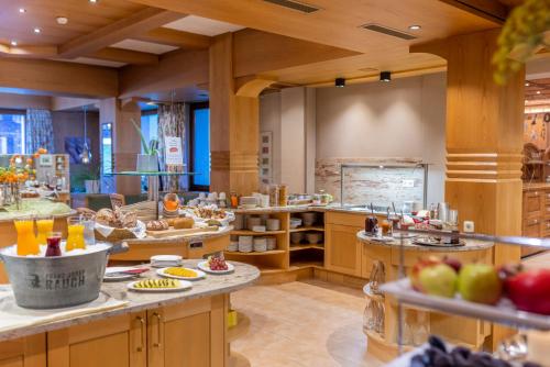a large kitchen with many different types of food at Hotel Walserberg in Warth am Arlberg