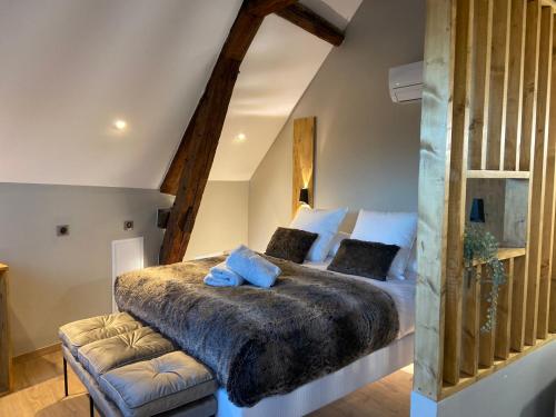 a bedroom with a large bed and a chair at LA TOUR YVELINE in Romans-sur-Isère