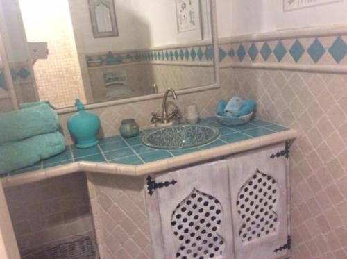 y baño con lavabo y espejo. en Molino Cottage en Estepona