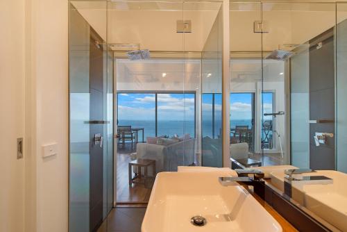 a bathroom with two sinks and a mirror at Seafarers Getaway in Apollo Bay