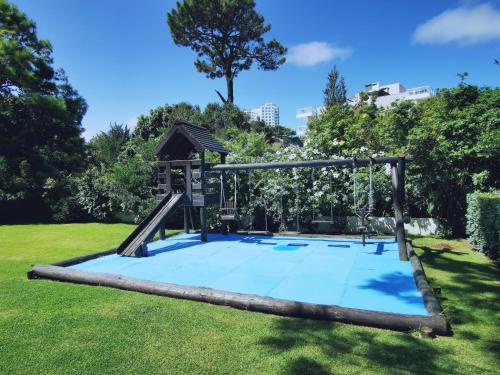 a playground in a park with a slide at Apartamento de un dormitorio en Edificio "Luna de Mar" in Punta del Este
