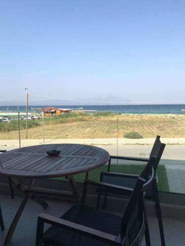a table and chairs on a balcony with a view of the beach at Onar Sarti Luxury Living in Sarti
