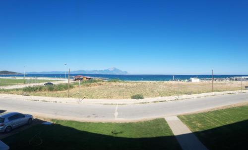 a road with a car parked next to the beach at Onar Sarti Luxury Living in Sarti
