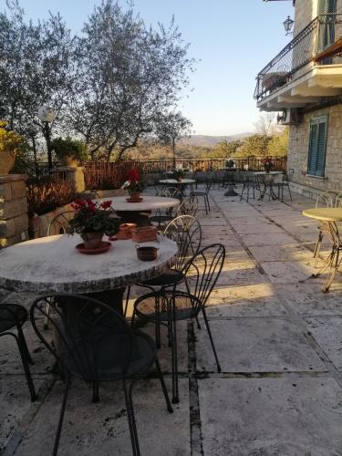 a group of tables and chairs on a patio at B&B Villa Miramì in Saturnia
