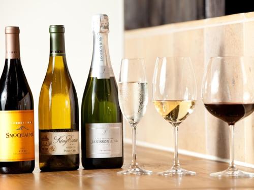 three bottles and two glasses of wine on a table at Koyado Enn in Toyooka