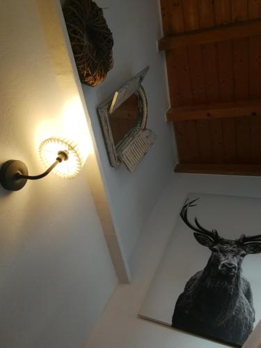 a lamp with a picture of a deer on a wall at Siegen Altstadt Oberstadt Häuschen in Siegen