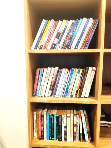 a book shelf filled with lots of books at Captains Paradise Luxury Resort at Mukteshwar Hill Station in Mukteswar