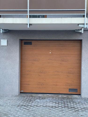 a wooden garage door on the side of a building at Deluxe apartmán Liščí kopec in Vrchlabí