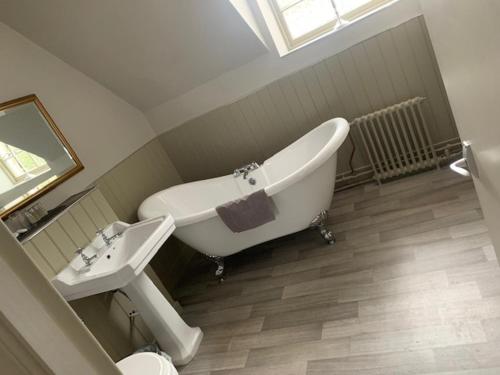 a bathroom with a bath tub and a sink at The Stair Arms Hotel in Edinburgh