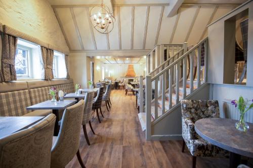 a row of tables and chairs in a restaurant at The Stair Arms Hotel in Edinburgh