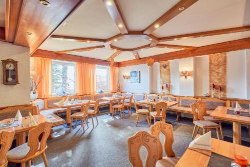a dining room with wooden tables and chairs at Landhotel Krone in Oberreute