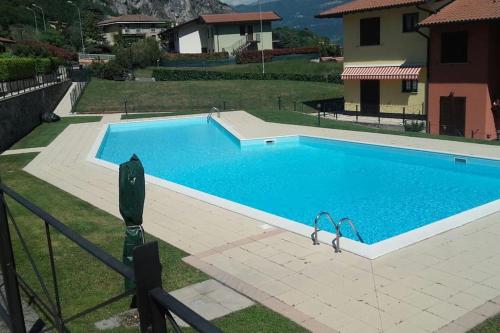 a swimming pool in a yard next to a house at Luxurious attic-swimming pool in Riva di Solto