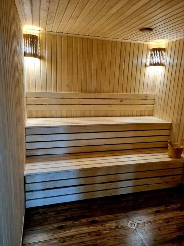 a wooden sauna with two wooden benches in it at Rubin Hotel in Goris