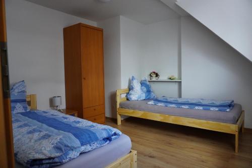 a bedroom with two beds and a cabinet at König Ferienhaus in Königsbrück