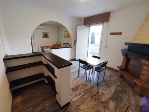 a living room with a table and a piano at B&B SunBeach in San Benedetto del Tronto