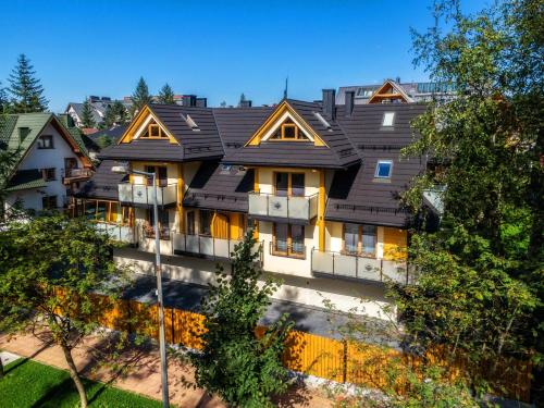 a large house with a black roof at Willa pod Orłem - Zakopane in Zakopane