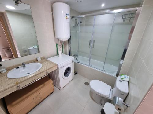 a bathroom with a sink and a washing machine at Avenida de Juan Sebastián Elcano Apartamento 1A02 in Vera