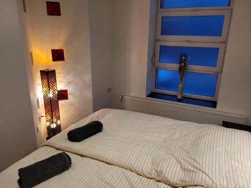 a bedroom with a white bed with a window at Lovely Apartment with free parking in Kecskemét