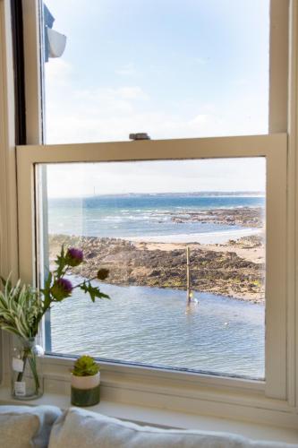a window with a view of the ocean at The Crusoe in Leven