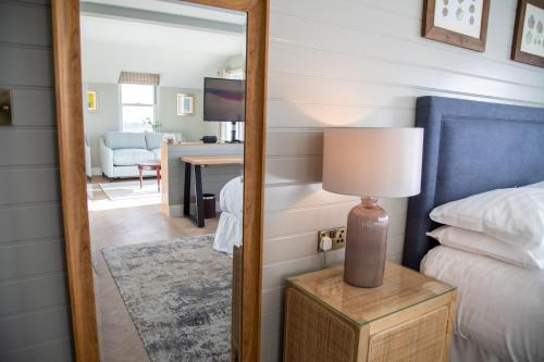 a mirror in a bedroom with a bed and a desk at The Crusoe in Leven