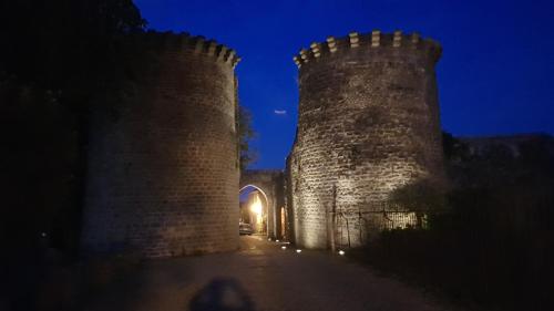 two towers of a castle at night at Appartement Capsea 4 étoiles, St Valery-sur-S, avec 2 parkings gratuits in Saint-Valery-sur-Somme
