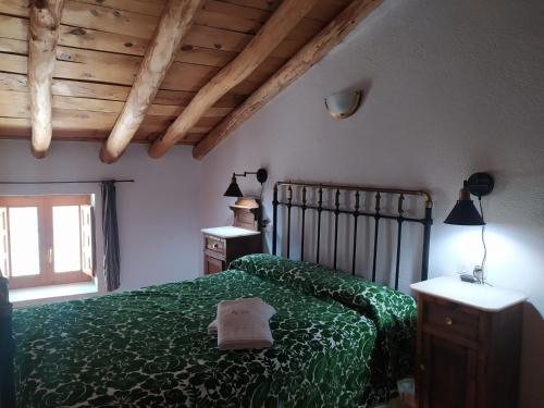 una camera da letto con un letto verde e una finestra di Casa Rural El Cortijo Nuevo, en El Cerezo a El Cerezo