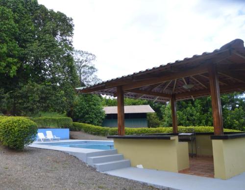 a pool with a pergola and a swimming pool at Epic Adventure Lodge in San Miguel