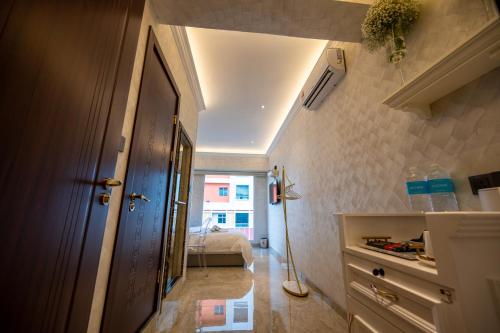 a hallway with a door and a bed in a room at ACJ Residence @ Beside Cititel Hotel in Kota Kinabalu