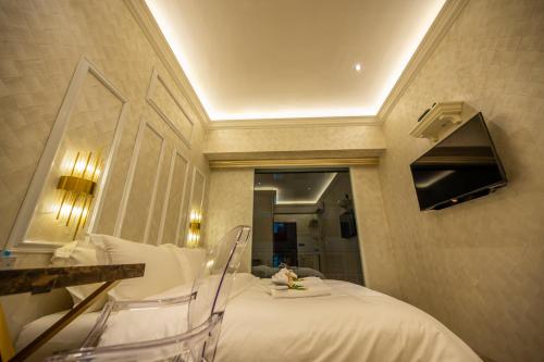 a hotel room with a bed and a mirror at ACJ Residence @ Beside Cititel Hotel in Kota Kinabalu
