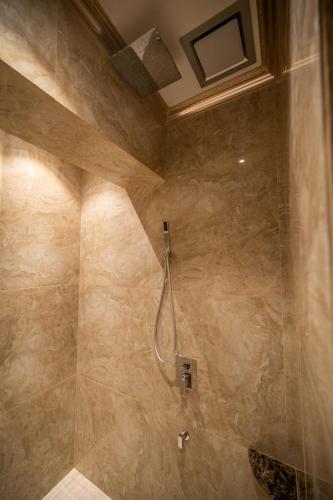a bathroom with a shower with a hose in it at ACJ Residence @ Beside Cititel Hotel in Kota Kinabalu