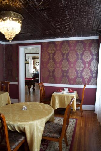 a dining room with two tables and purple walls at The Gridley Inn B&B in Waterloo