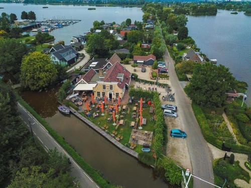 an aerial view of a house on an island in the water at Gîte81 in Reeuwijk
