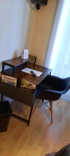 a table and a chair in a room at Le Gue de Genes in Ambrieres Les Vallees