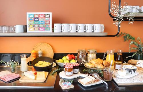 a table topped with lots of food on top at Appart'City Classic Paris La Villette in Paris