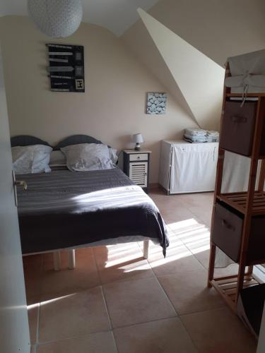a bedroom with a bed and a table at Les Gites de Kerdurod in Guidel