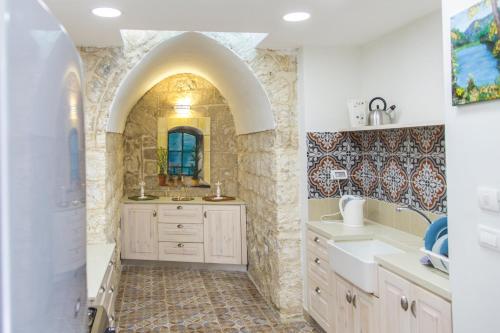 a bathroom with a sink and a mirror at Alexandra House in Nazareth