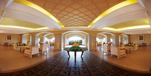 a lobby with chairs and a table in a building at Gateway Varkala in Varkala