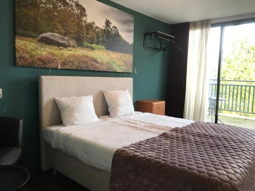Ένα ή περισσότερα κρεβάτια σε δωμάτιο στο Wapen van Exloo