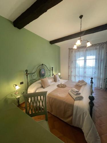 a bedroom with a large bed and a window at Agriturismo Il Gonzeto, Montepulciano in Montepulciano
