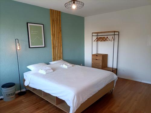 a bedroom with a bed and a dresser in it at Studio lumineux bien placé en ville de Sion in Sion