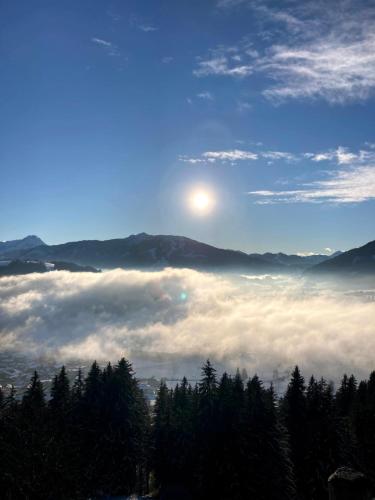 a view of the sun rising over a sea of clouds at Heissgut in Altenmarkt im Pongau