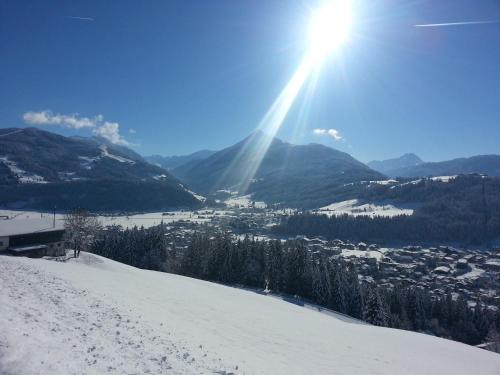 a view of a snow covered mountain with the sun shining at Heissgut in Altenmarkt im Pongau