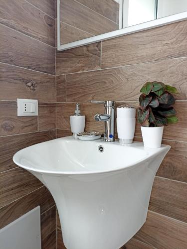 a bathroom with a white sink and a mirror at Kolossoi Guest House in Càbras