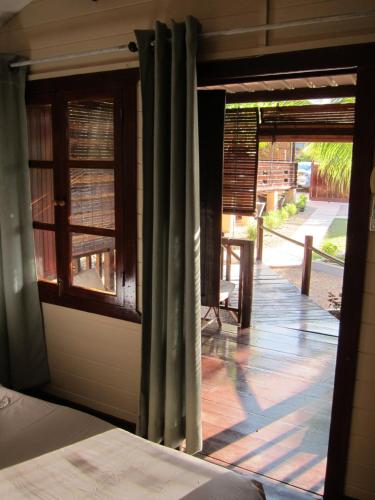 a room with a window with a view of a porch at LA CASE BOIS CRÉOLE in Albion