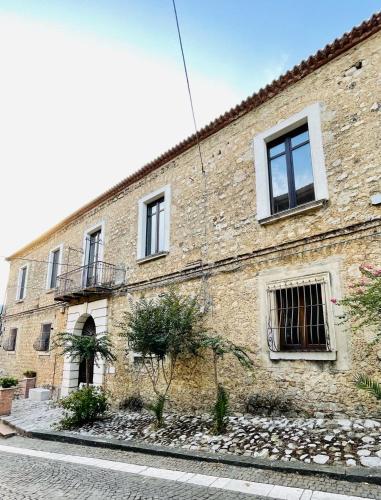 un edificio de ladrillo con ventanas en una calle en Palazzo Sabini, en Pertosa