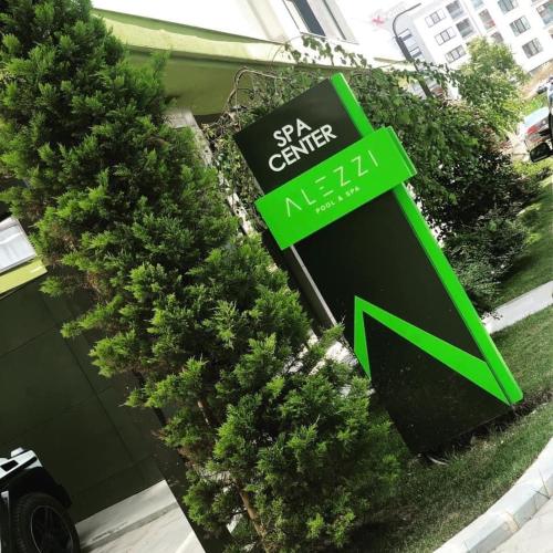a sign for a nissan dealership with a green arrow at Alezzi Seaside in Năvodari