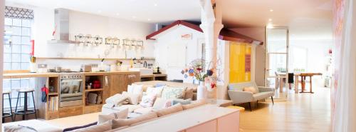 a living room with a couch and a kitchen at Flo's Atelier - Family studio NOTE studio is adjacent to Flo's apartment in Amsterdam