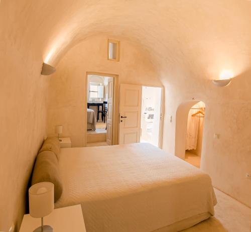 a bedroom with a bed and a living room at Castelli Torre in Emporio Santorini